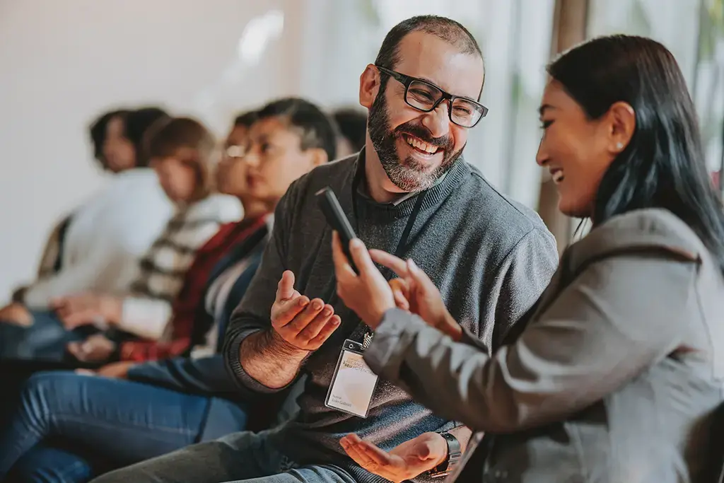 A man and woman engaged in conversation, sharing thoughts and ideas in a friendly manner.
